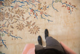 Plush Art Deco rug with sprawling ornate foliage and blue vines on an ivory field.