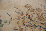 Plush ivory Art Deco rug detail with cobalt blue vines and blush, green, silver floral motifs.