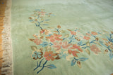 Plush Art Deco rug pile with sprawling floral vines in seafoam green, blush, and blue.