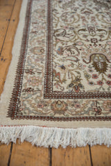 Detailed corner of a vintage Tabriz runner showing its full pile, intact selvage, and white fringe.