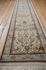 Angled view of a vintage Tabriz runner highlighting its full length and intricate floral pattern.