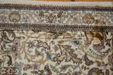 Detailed view showing the localized stain on the vintage Tabriz runner's ivory field.