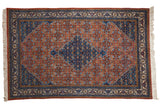 Vintage Ardebil carpet, terra cotta rust field, sapphire blue diamond medallion with turtle finials, Herati motif.