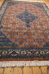 White fringe and intricate floral border of a vintage Ardebil carpet with Herati motif.