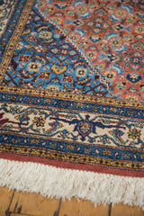 Vintage Ardebil rug's fine beige border, colorful hand-knotted patterns, and white fringe.