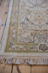 Vintage Tabriz runner corner with intricate vinery, ivory pile, green border, and original fringe.
