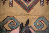 Detail of vintage Meshkin carpet with deep ocean green and rust mountainous diamond pattern.