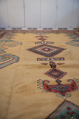 Oversized scrolling rams horn design on a textured pale ochre field of a vintage Meshkin carpet.