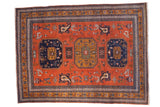 Vintage hand-knotted Ardebil carpet with triple geometric medallion, rust, navy, and bronze.