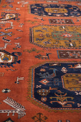 Terracotta field, navy geometric patterns, hook and latch motif, and stylized animals.