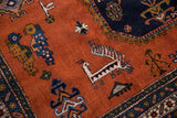 Playful geometric birds and animals on the rust field of a vintage Ardebil rug.