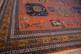 Vintage Ardebil carpet corner, pale rust field, geometric navy medallion, patterned borders.