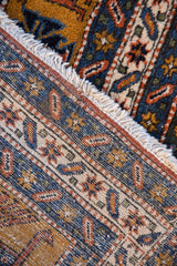 Tight hand-knotted foundation of the vintage Persian Ardebil carpet in navy, rust, and ivory.