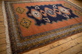 Geometric navy, gold, ivory border detail on a vintage Meshkin carpet corner.