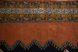 Intricate geometric borders in navy, sky blue, ivory. Stepped motif against dusty sandalwood field.