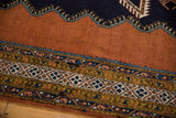 Sandalwood field, serrated blue edge, and geometric borders of a vintage Meshkin carpet.