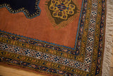 Hand-knotted Meshkin rug corner with terracotta field, finned medallion, geometric borders, natural fringe.