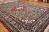 Vintage Ardebil carpet corner, moss green field with rust and ivory geometric borders.