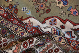 Vintage Ardebil carpet's plush pile showing moss green, rust, ivory floral and geometric motifs.