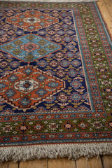 Hand knotted Ardebil rug fringe and geometric border in green, rust, blue.