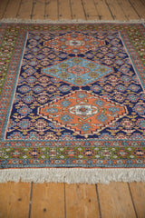 Vintage Ardebil rug: full pile fringe and detailed border with navy, terra cotta, green patterns.