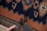Vintage Ardebil carpet: navy field, finned geometric motif, and wide dusty sandalwood border.
