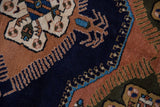 Vintage Ardebil carpet's finned pattern details in navy, dusty sandalwood, and sky blue.