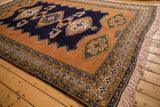 Vintage Ardebil carpet corner with sandalwood field, geometric border, and a finned bird.