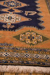 Fringe and corner detail of vintage Ardebil carpet, navy field with sandalwood finned motifs.