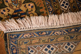 Ardebil carpet's intact light fringe and traditional borders with navy, gold, olive finned patterns.