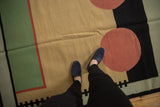 Abstract geometric contemporary kilim pattern in beige, deep blush, black, and mallard green.