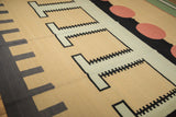 Interlocking stepped geometric pattern on a vintage Indian Kilim in beige and dark grey.