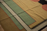 Geometric design detail of the Indian Kilim with mallard green, sand, and black elements.