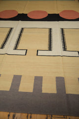 Interlocking beige, black, and coffee-toned geometric pattern detail on the contemporary Kilim rug.