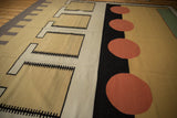 Contemporary Kilim carpet showcasing abstract geometric pattern of beige rectangles and cinnabar red circles.