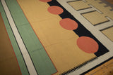Vintage Indian contemporary Kilim detail with mallard green, cinnabar red circles, and black geometric patterns.