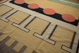 Indian Kilim's upper edge: mallard green, white, cinnabar red stripes, orange geometric circles.