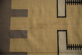 Abstract geometric detail of vintage Indian Kilim rug with beige, black, and ivory.