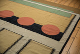 Detail of vintage Indian Contemporary Kilim rug with cinnabar red circle, black and beige interlocking geometric pattern.