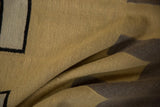 Close-up of handwoven vintage Indian Kilim texture in beige, black, and oxidized silver.