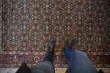 Intricate green Herati pattern and a detailed rust-red border on the vintage Bulgarian rug.