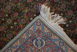 Hand-knotted foundation and intricate blue, red, and ivory border of a vintage Tabriz rug.