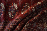 Dynamic folds highlighting the lustrous, silk-like pile of a fine Pakistani Bokhara rug.