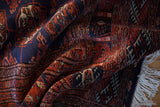 Deep folds in a vintage Pakistani Bokhara rug reveal its plush wool pile and lustrous sheen.