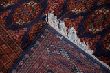 View of the original side cord selvage and full fringe on a hand-knotted Bokhara style carpet.