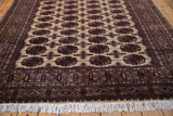Angled corner view of a Bokhara rug showing the plush wool pile, detailed border, and clean ivory fringe.