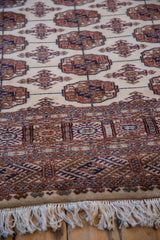 Detailed view of a Bokhara rug's intricate border, plush wool pile, and soft ivory fringe.