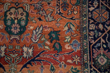 Rust field with green gul ferang scrolling rose motifs transitioning to the navy main border.