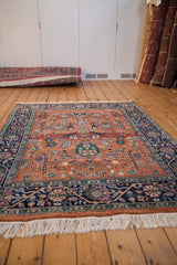 White fringe and navy blue meandering vine main border of the Indian Bijar design rug.