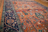 Gul ferang motif on rust field with navy meandering vine border of a vintage Indian Bijar rug.